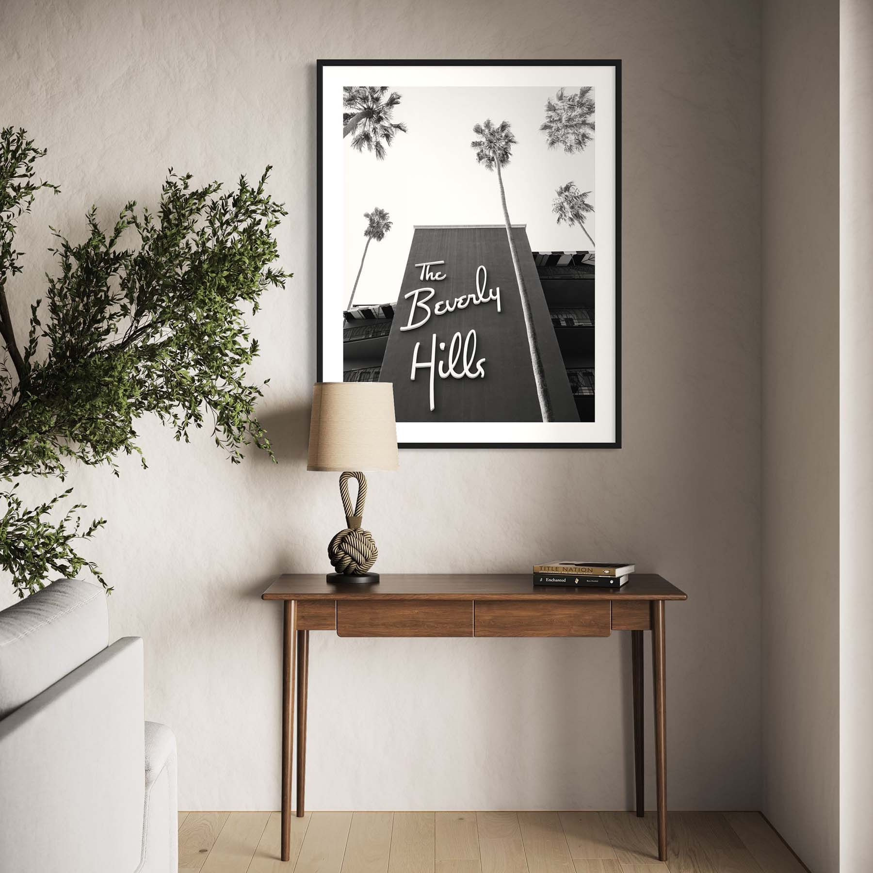 A framed black and white photograph of the Beverly Hills Hotel hangs on the wall in a contemporary-themed living room.