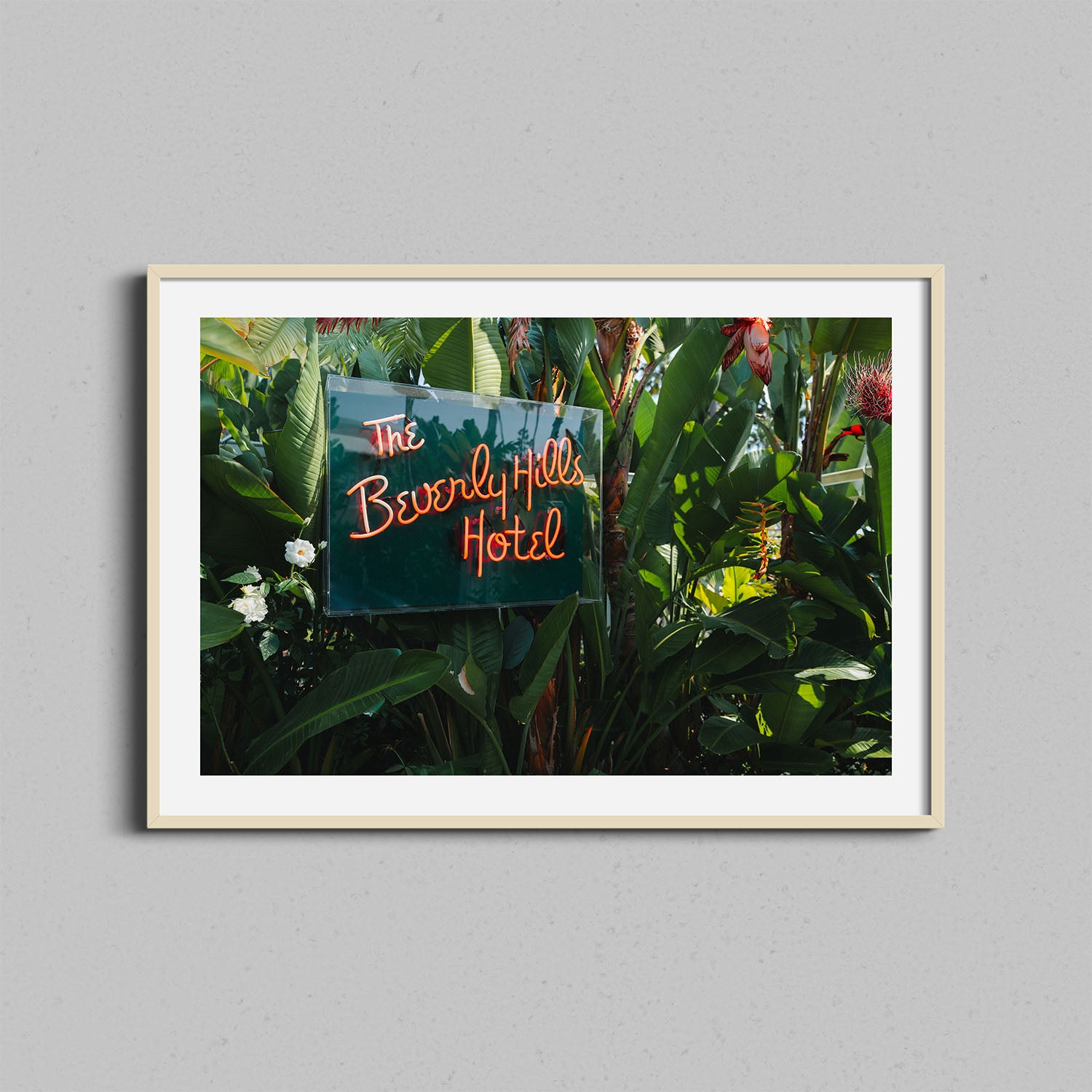 A fine art photograph of the Beverly Hills Hotel neon signed framed in a natural wooden frame.