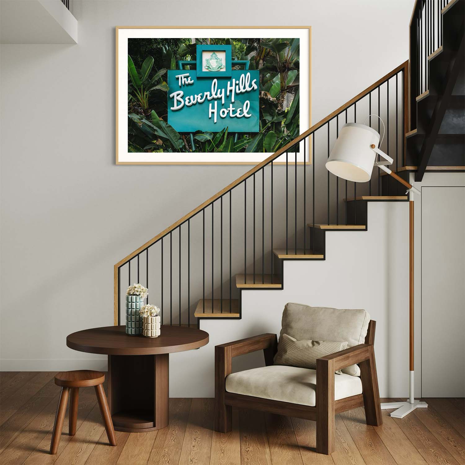 A photograph of the Beverly Hills Hotel entrance sign hangs on the wall near a modern staircase.