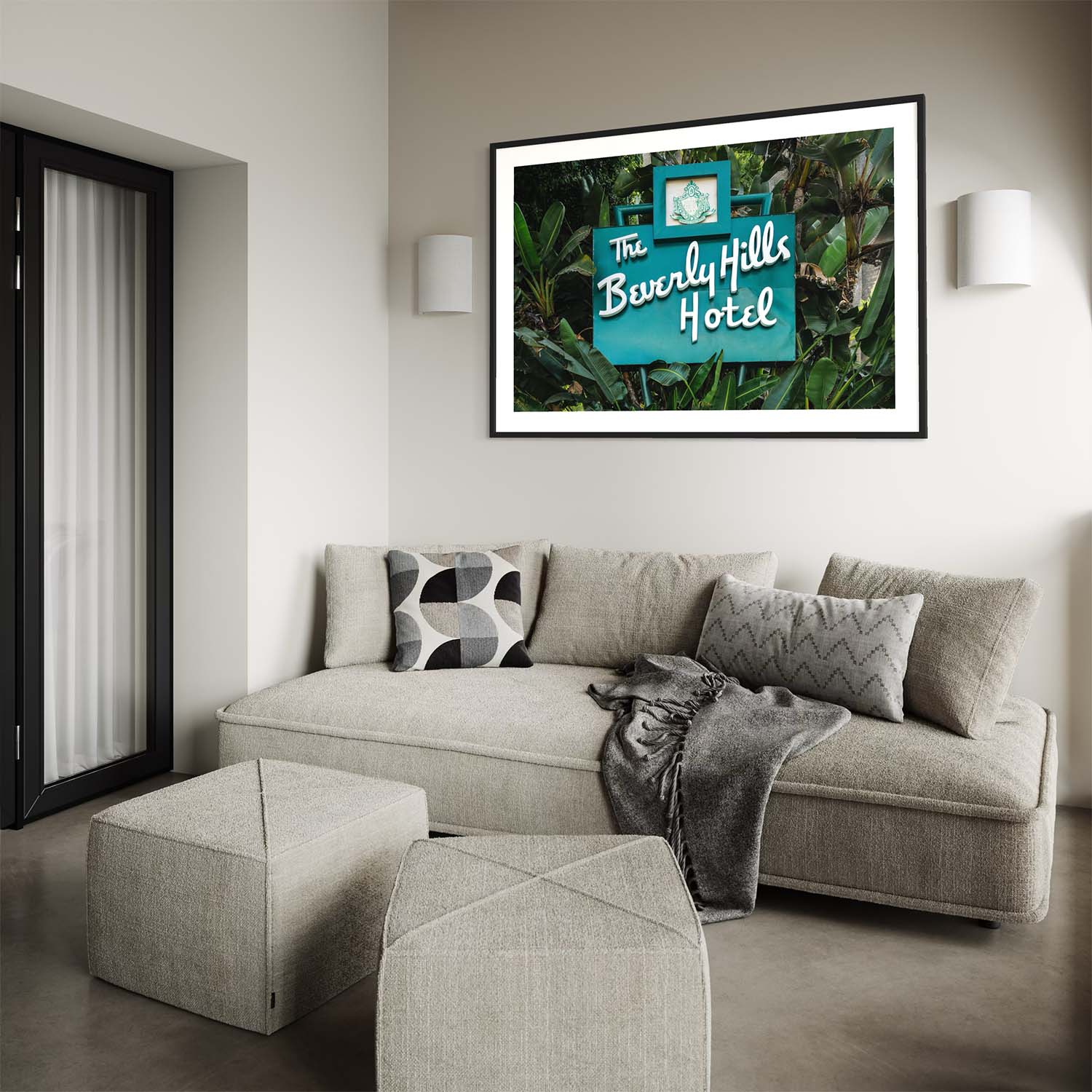 A photograph of the Beverly Hills Hotel entrance sign hangs on the wall over a contemporary couch.