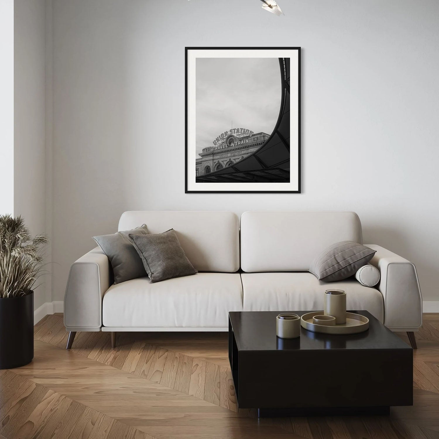 A black and white photography print of Denver's Union Station on a wall in a mid-century modern living room.
