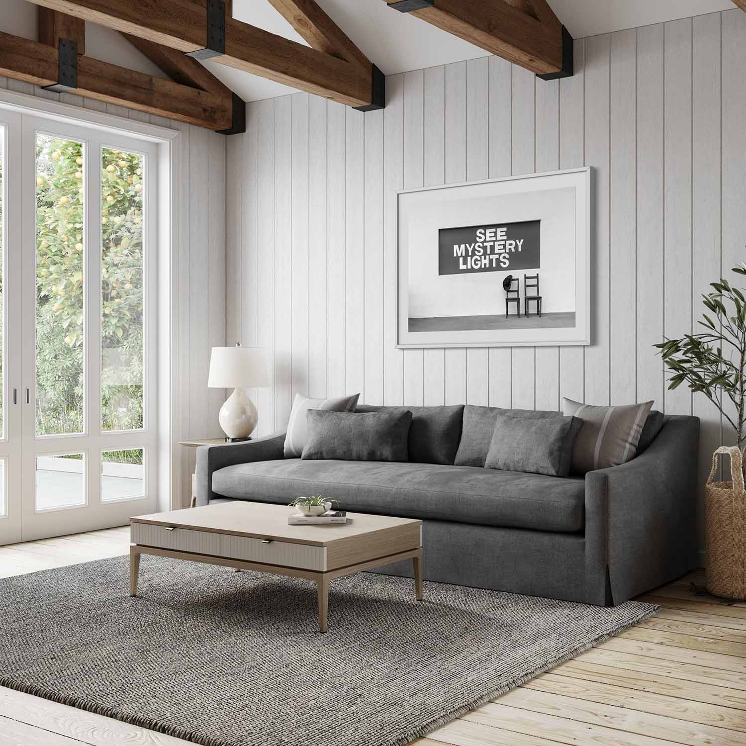 A black and white photography print of Marfa, Texas' See Mystery Lights sign hanging in a mid-century modern living room.
