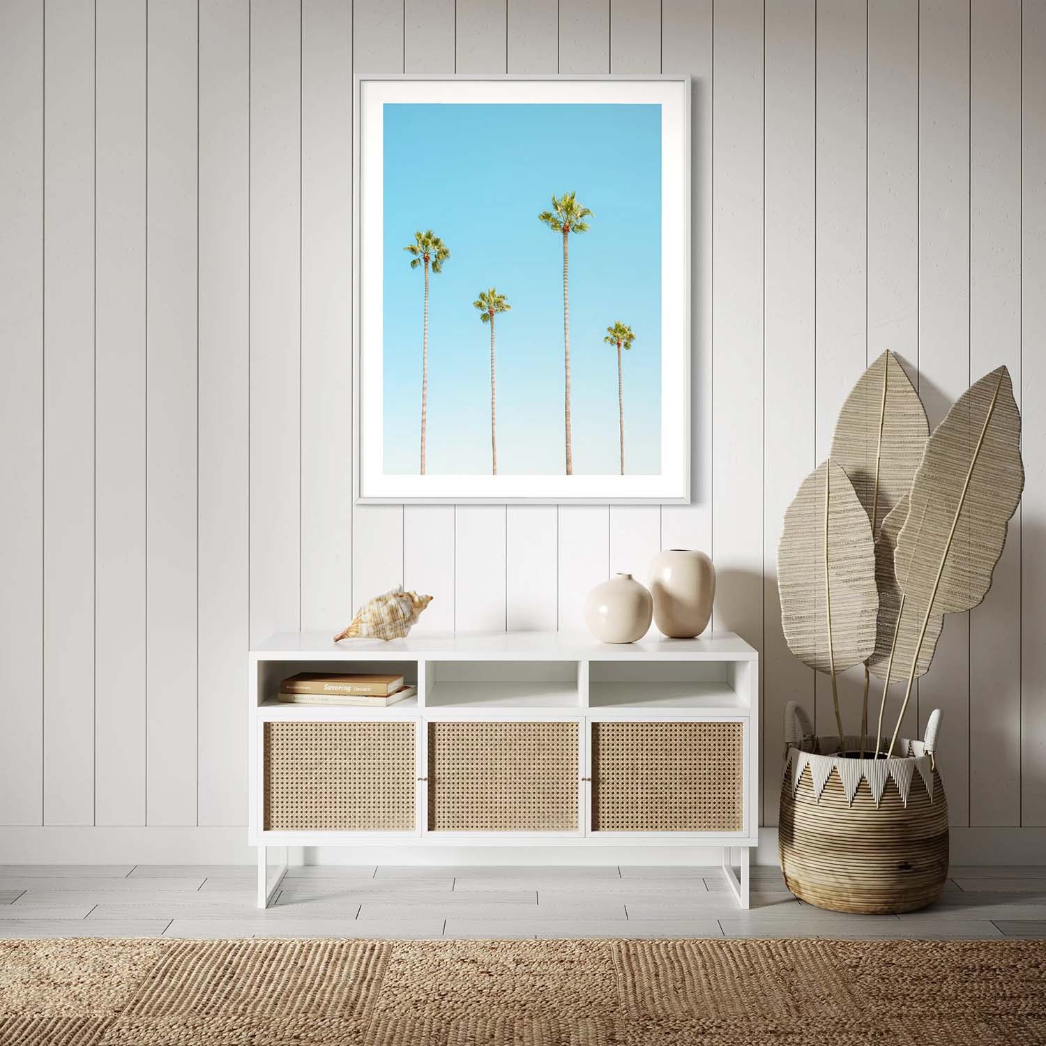 A framed photo of four palm trees hangs on the wall in a coastal-inspired entryway.