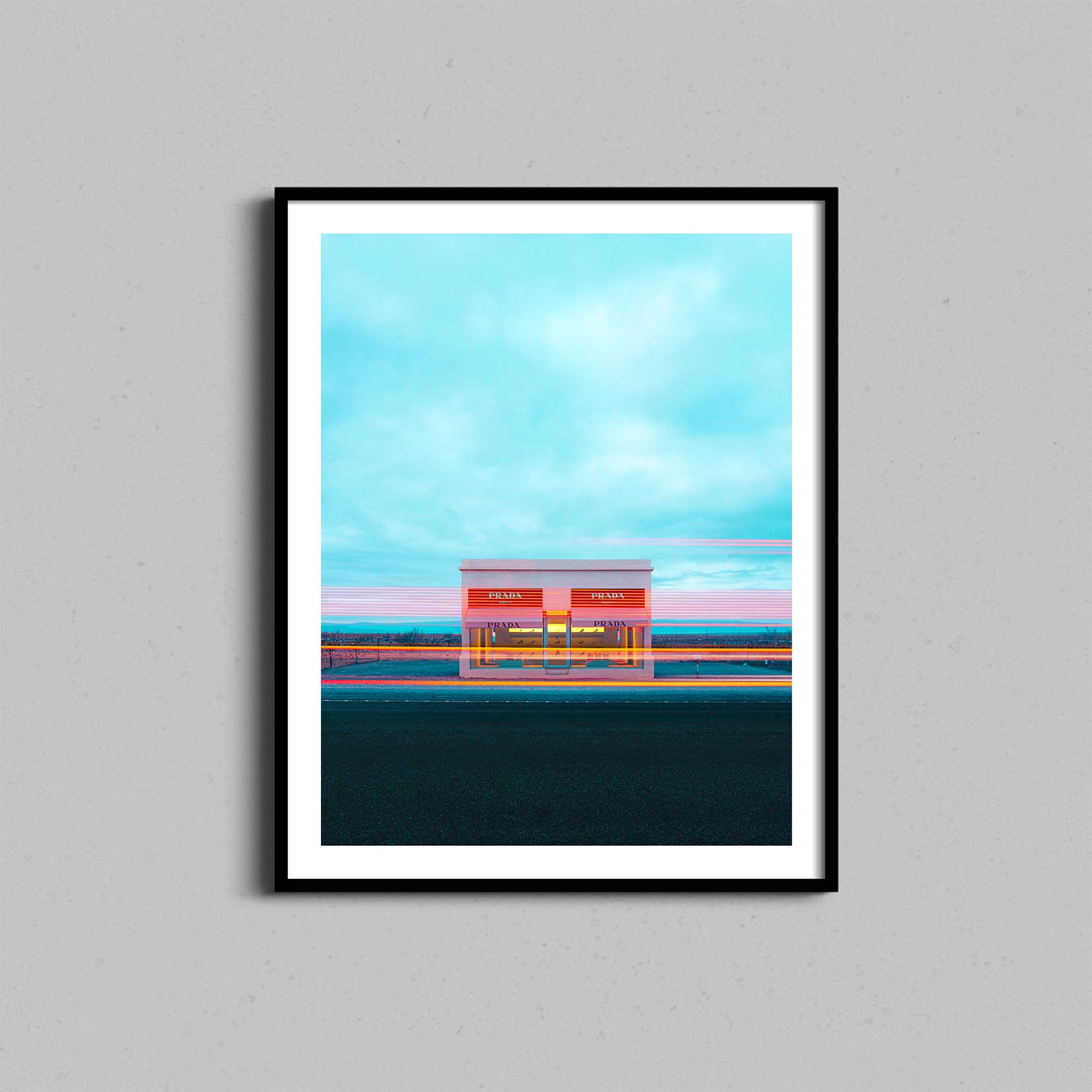 A photograph of the Prada Marfa art installation framed with a black wooden frame.