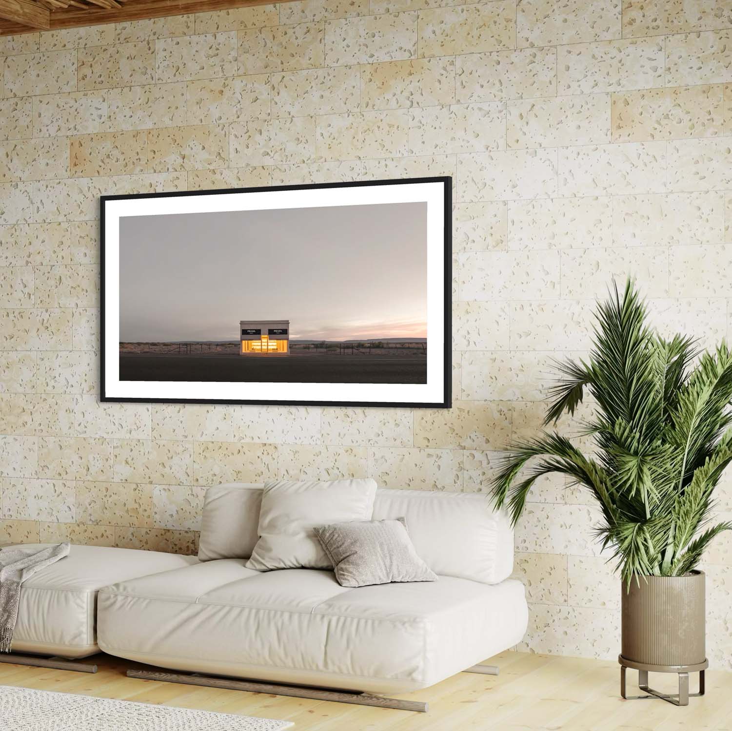 A panoramic photo of the Prada Marfa store hangs on the wall in a mid century modern living room.