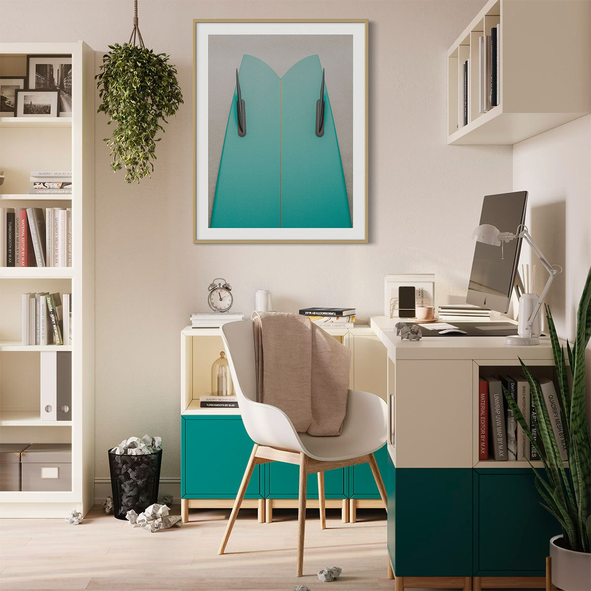 A framed coastal photograph featuring a green surfboard in a natural wooden frame. The art hangs on a wall in a modern office with green shelves.