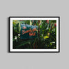 A fine art photograph of the Beverly Hills Hotel neon signed framed in a black wooden frame.