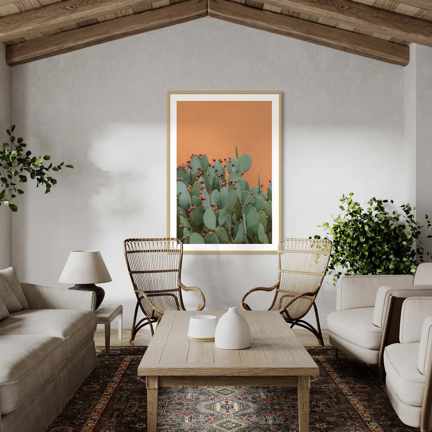 A photography print of prickly pear cactus and orange textured wall hanging in a southwestern-inspired living room.