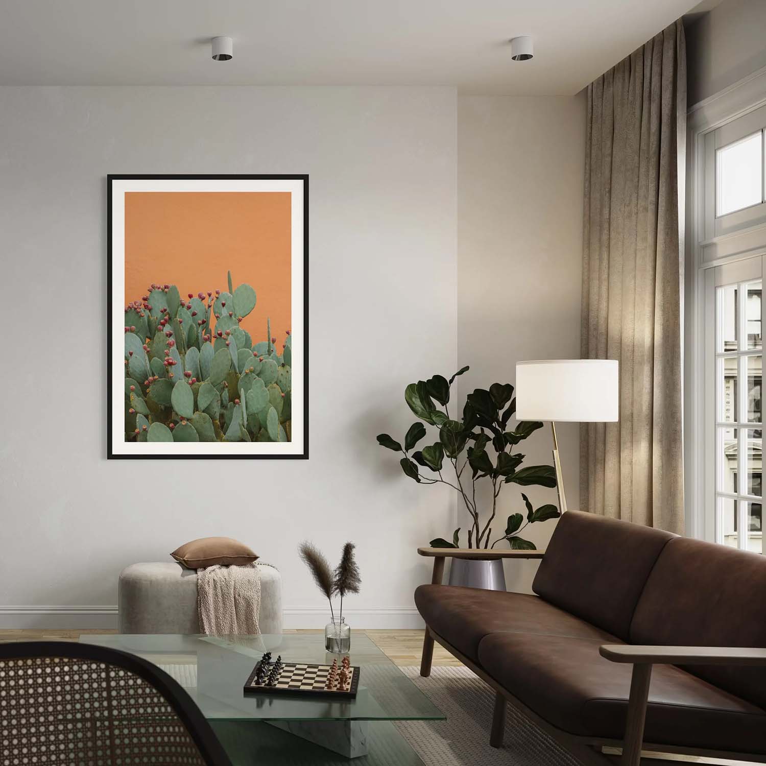 A photography print of prickly pear cactus and orange textured wall hanging in a contemporary-designed living room.