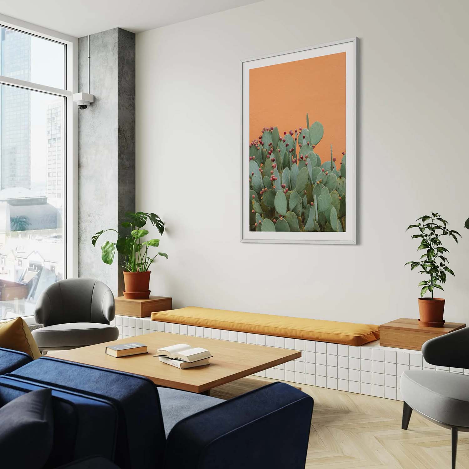 A photography print of prickly pear cactus next to an orange textured wall hanging in a southwestern-inspired entryway.