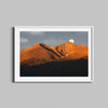 Colorado's Longs Peak at sunrise with the moon setting behind framed in a white wooden frame.