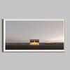 A panoramic photo of the Prada Marfa store framed in a natural wooden frame.