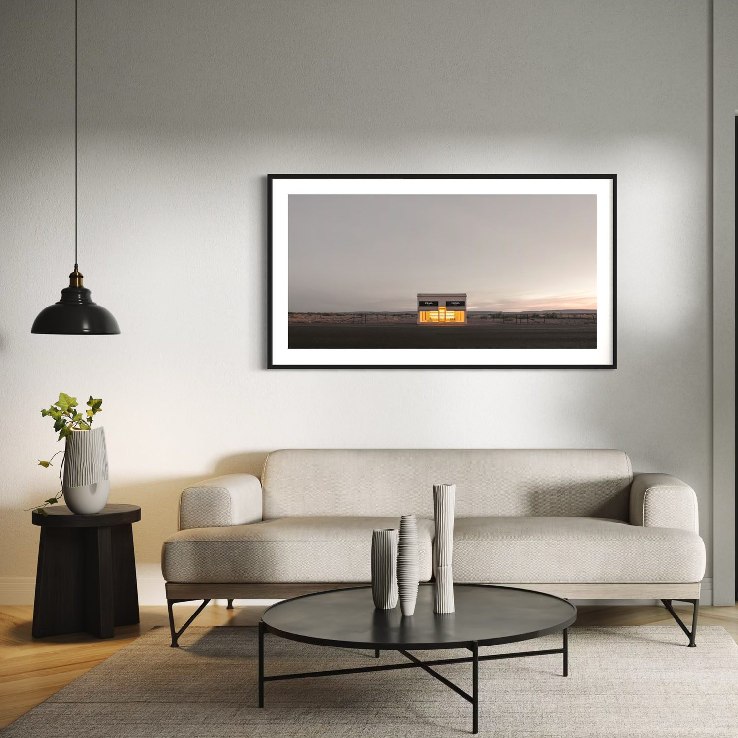 A panoramic photo of the Prada Marfa store hangs on the wall over a couch in a modern styled living room.