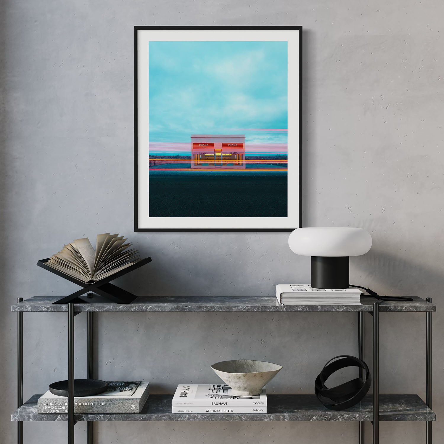 A framed photograph of the Prada Marfa art installation hanging on the wall in a mid century entryway.