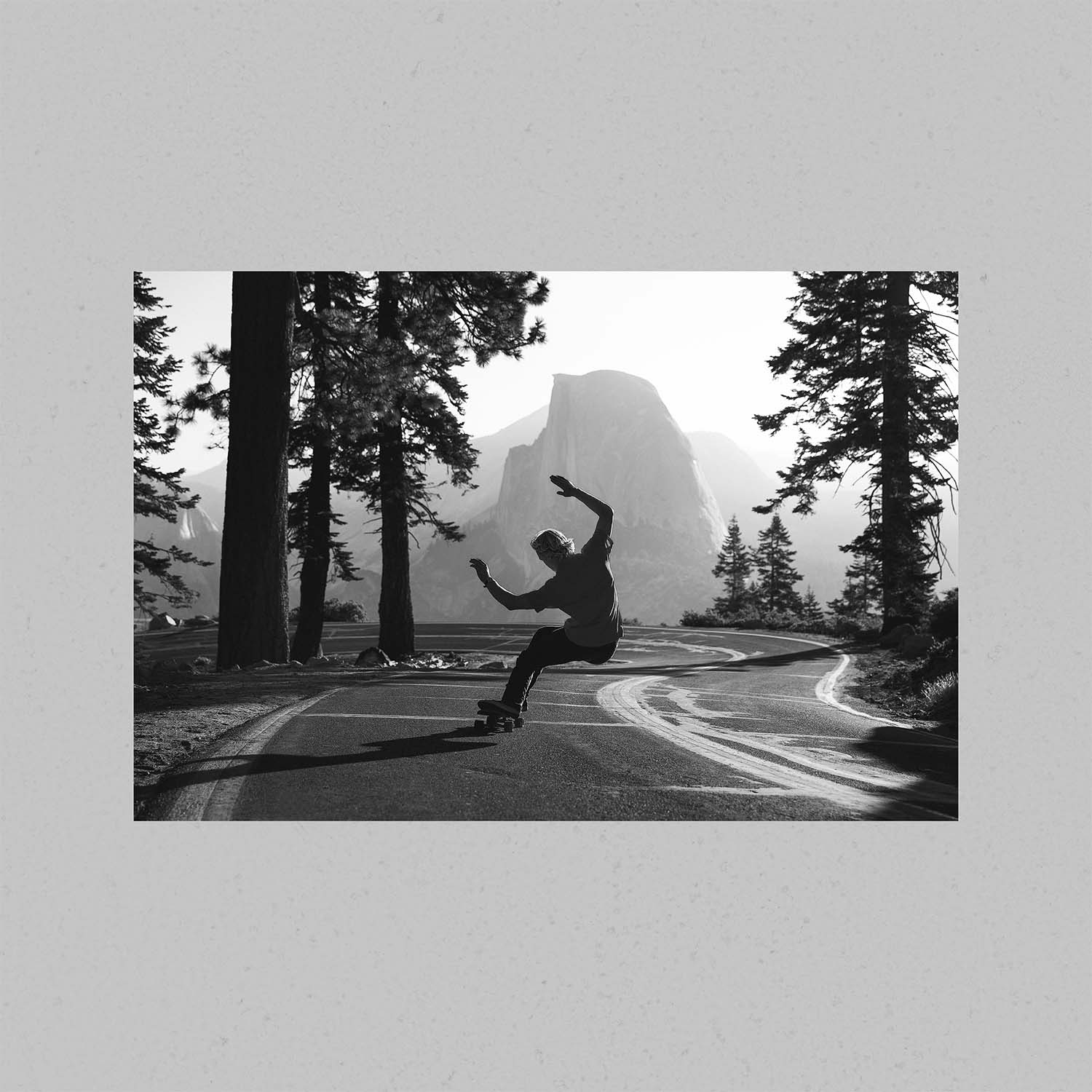 A photograph of a skateboarder skating in Yosemite National Park