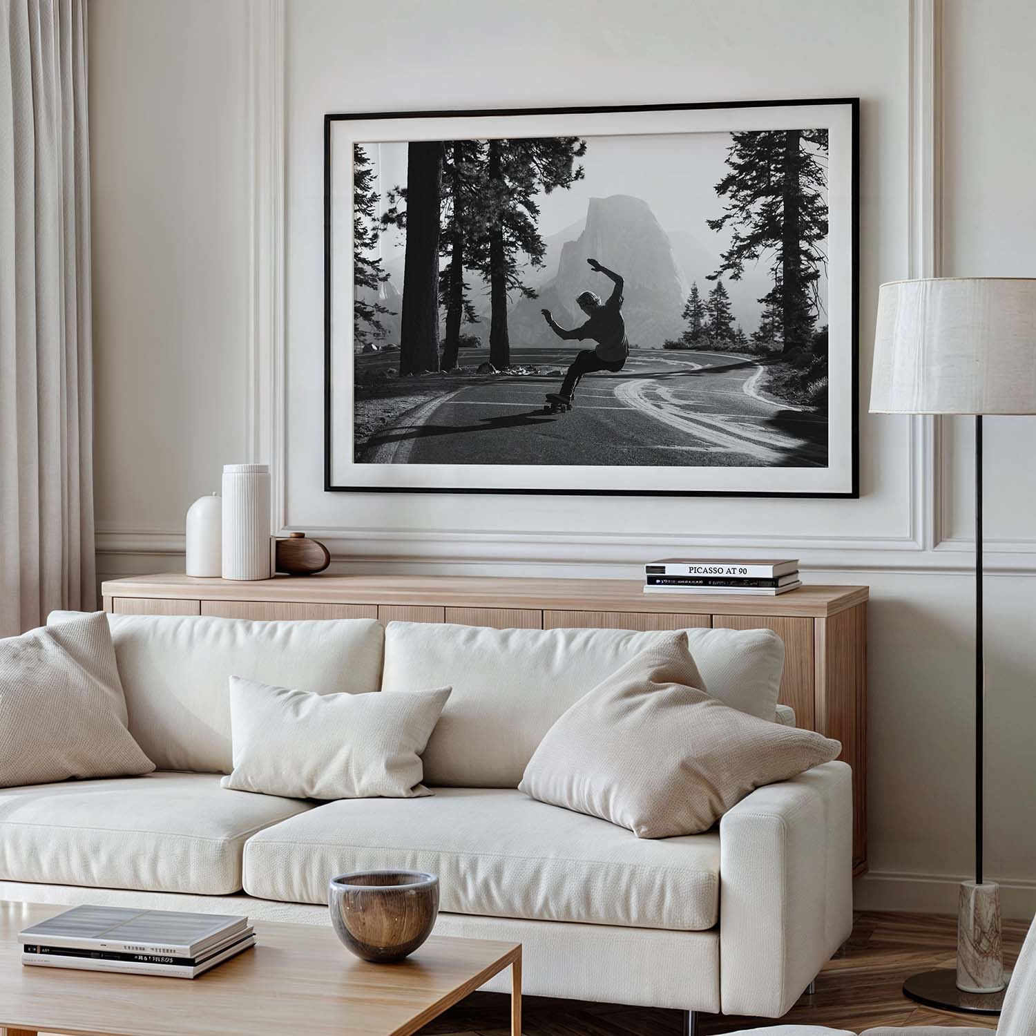 A framed photograph of a skateboarder in Yosemite National Park hangs on a wall in a modern living room.