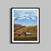 A photograph of barns outside of Telluride, Colorado hangs on a wall in a black wooden frame.