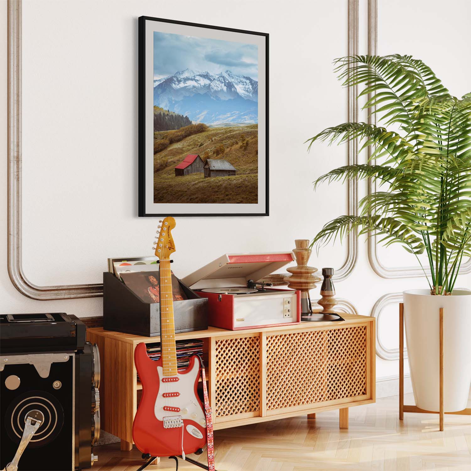 A photograph of barns outside of Telluride, Colorado hangs on a wall over a record player in a modern living room.