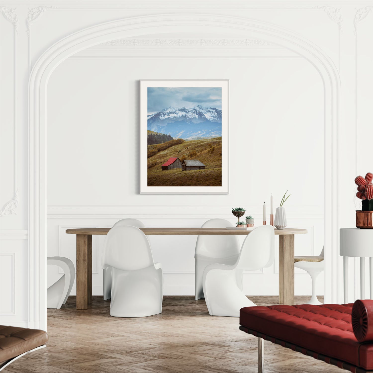 A photograph of barns outside of Telluride, Colorado hangs on a wall in a modern dining room.