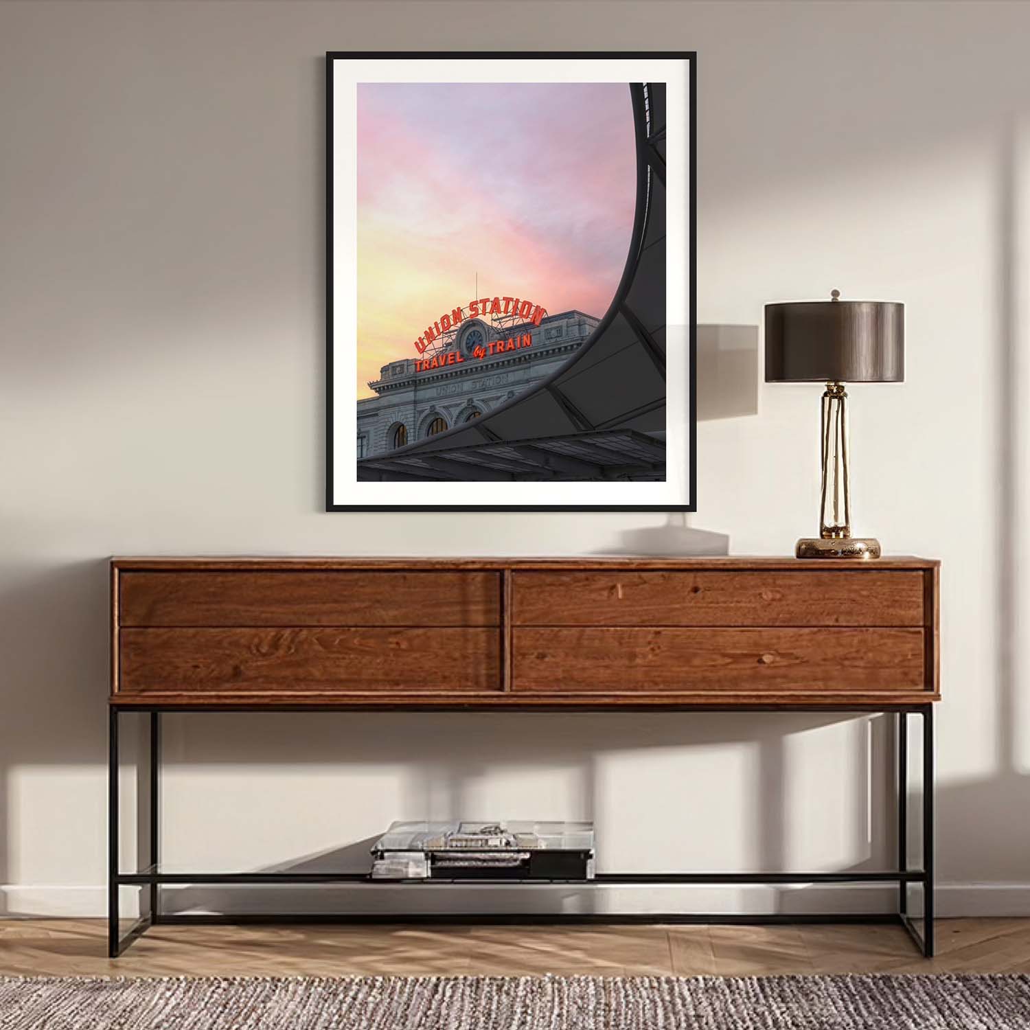 A fine art photography print of Denver's Union Station hangs above a table in a mid-century modern entryway.