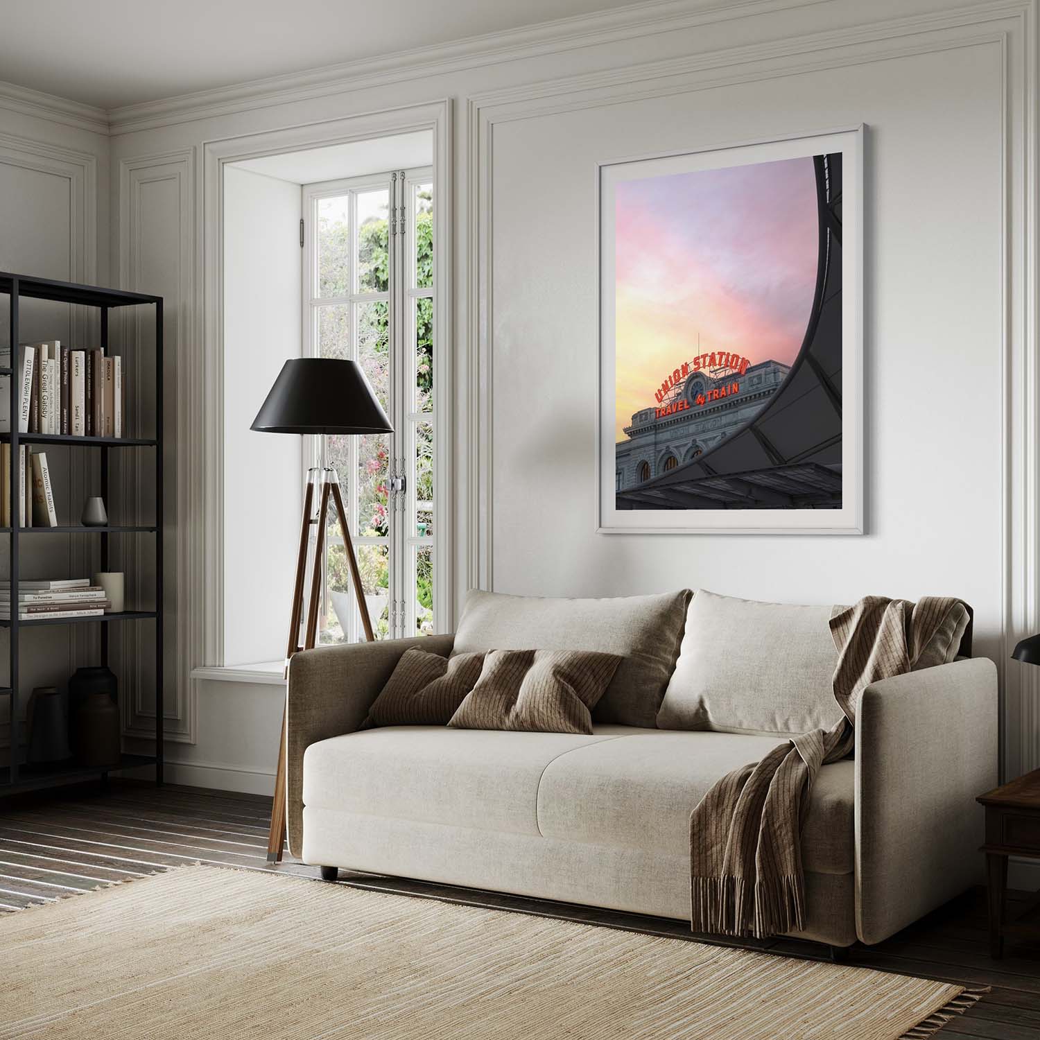 A fine art photography print of Denver's Union Station hangs above a couch in a mid-century modern living room.